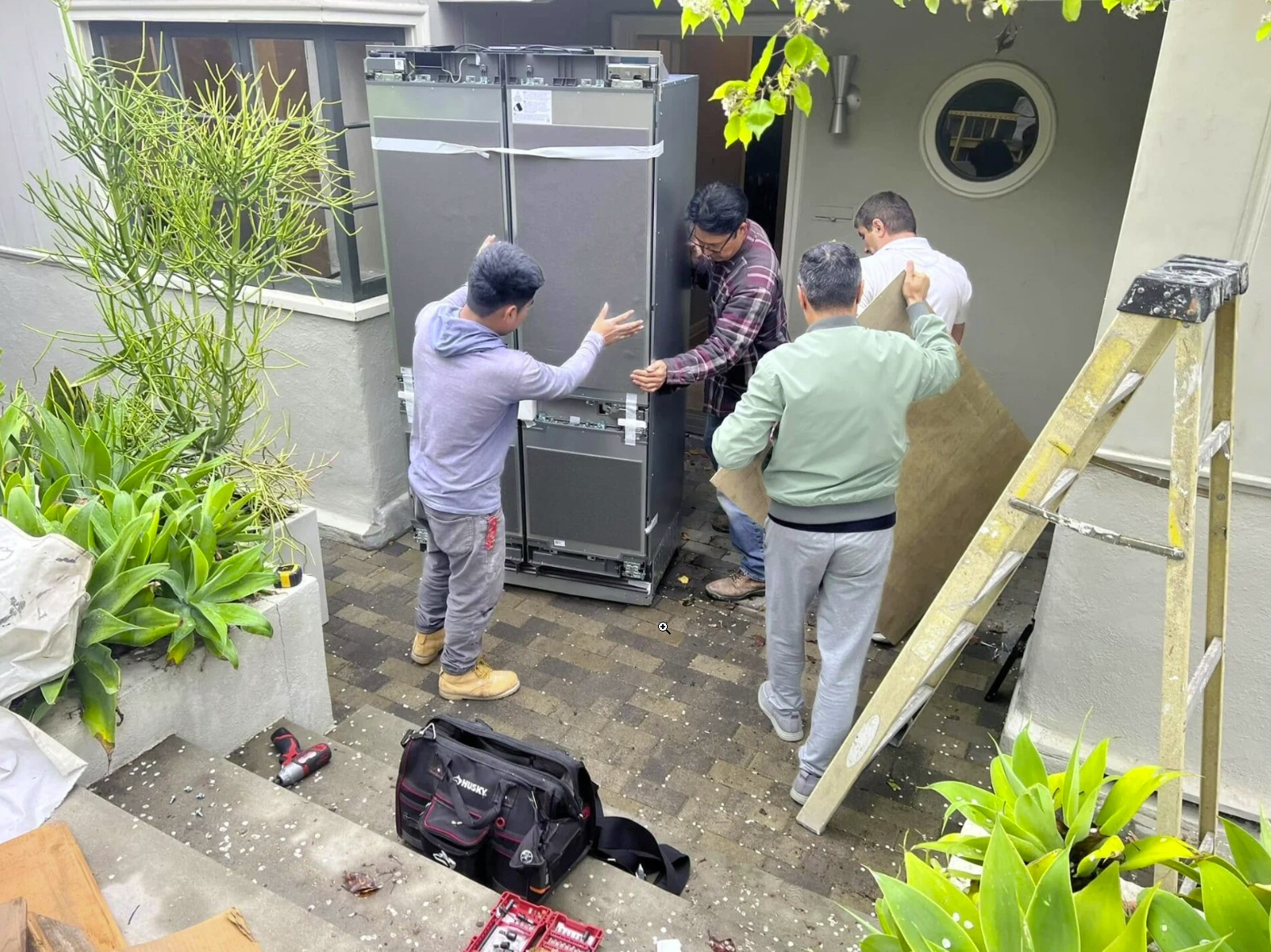 Team installing outdoor refrigerator unit